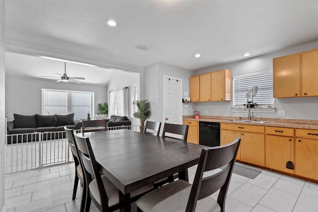 dining space featuring ceiling fan, sink, vaulted ceiling, a textured ceiling, and light tile patterned floors