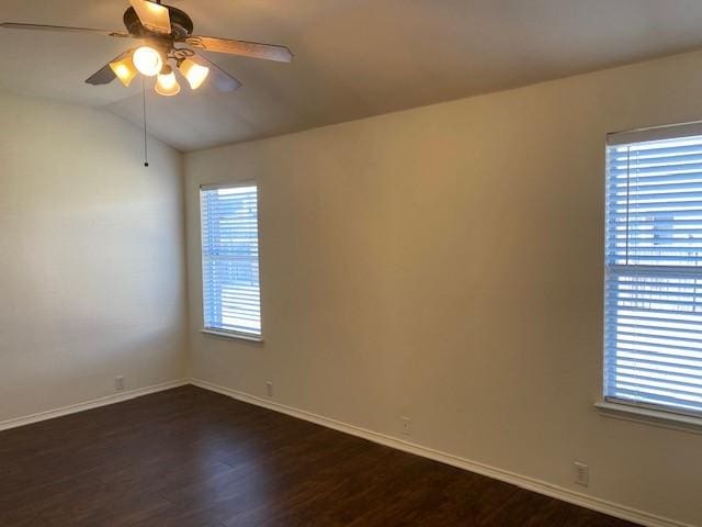 spare room featuring ceiling fan, dark hardwood / wood-style floors, and lofted ceiling