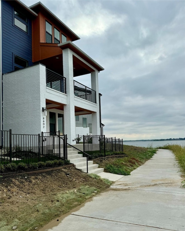 view of home's exterior with a water view