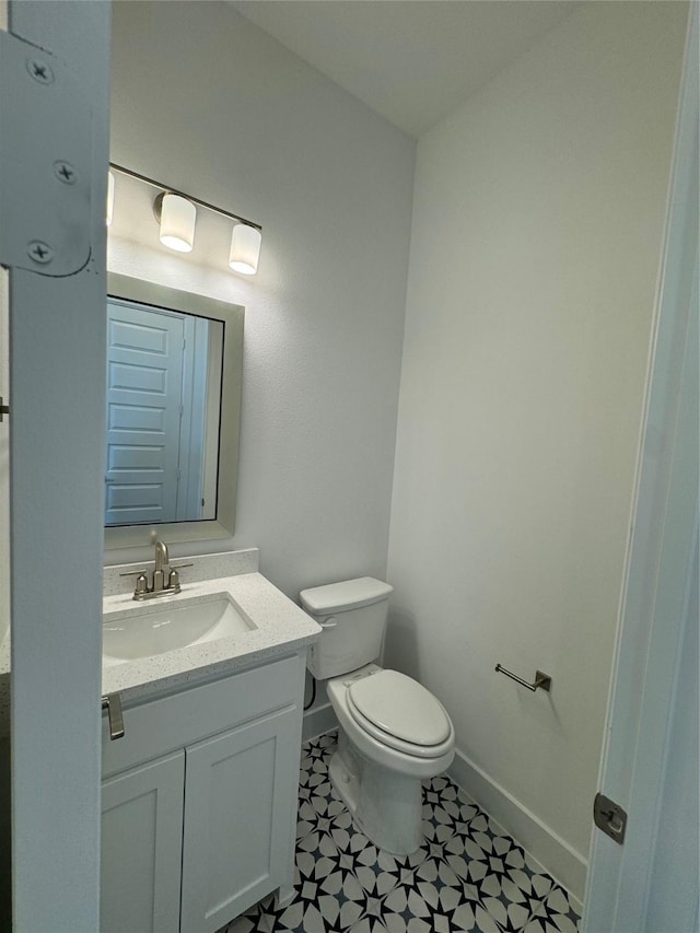 bathroom featuring vanity and toilet