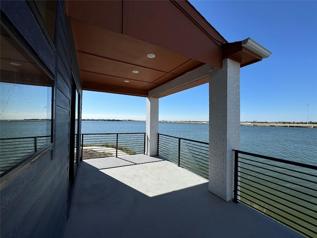 view of patio / terrace featuring a water view and a balcony