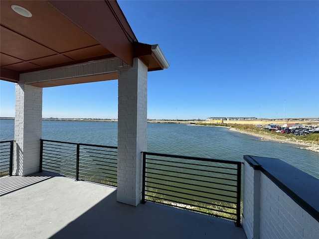 exterior space featuring a balcony and a water view