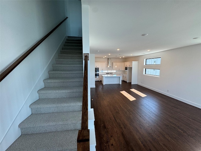 stairway featuring wood-type flooring