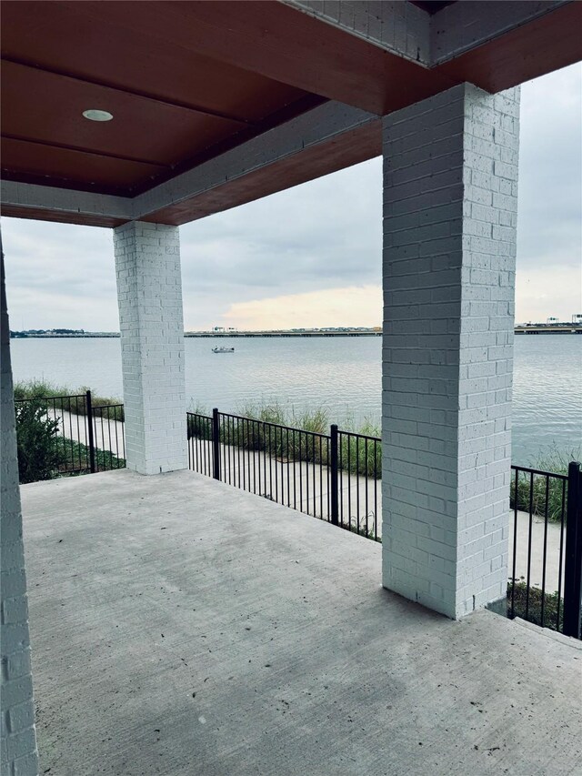 view of patio with a water view