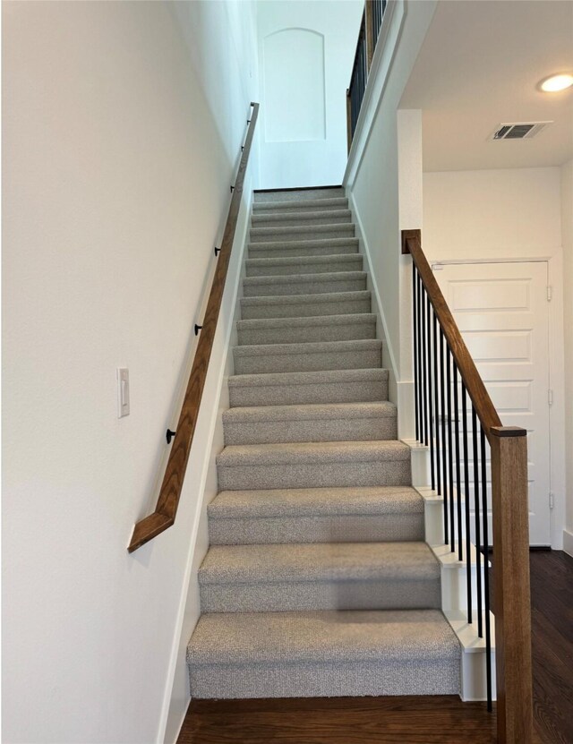 stairs with wood-type flooring