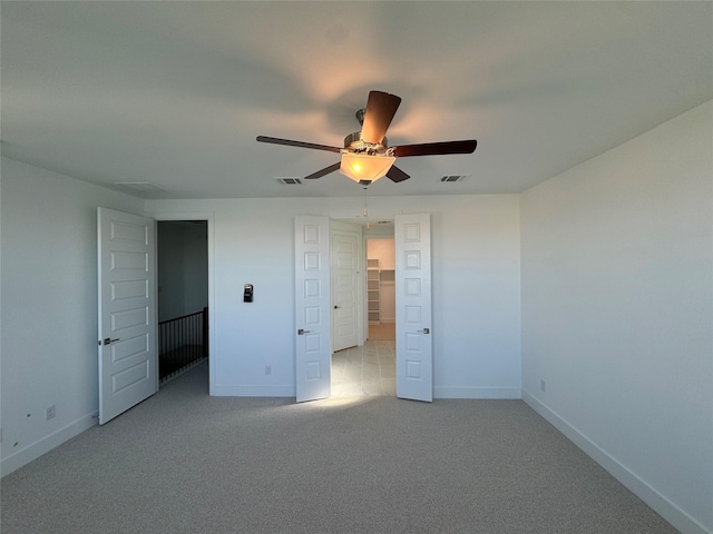 unfurnished bedroom featuring ceiling fan and light colored carpet