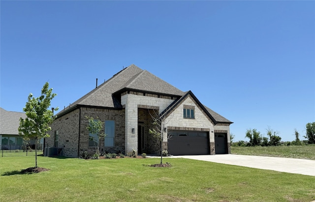 203 Links Ct, Heath, TX 75032 - french country home with concrete driveway, stone siding, central AC unit, an attached garage, and brick siding