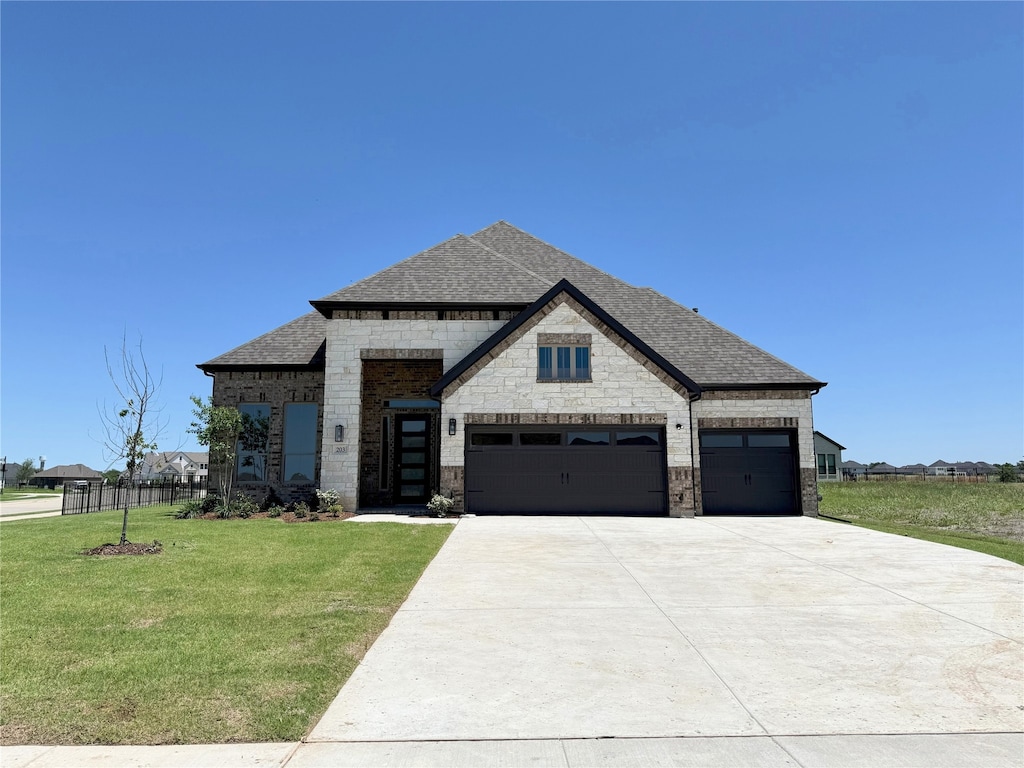 203 Links Ct, Heath, TX 75032 - french country inspired facade with roof with shingles, an attached garage, driveway, stone siding, and brick siding