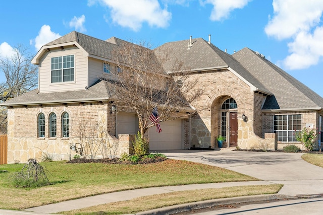 view of front of house featuring a garage and a front yard