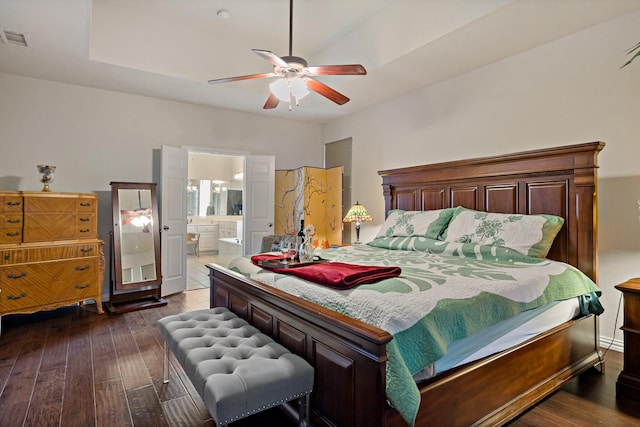 bedroom with dark hardwood / wood-style flooring, ensuite bath, and ceiling fan