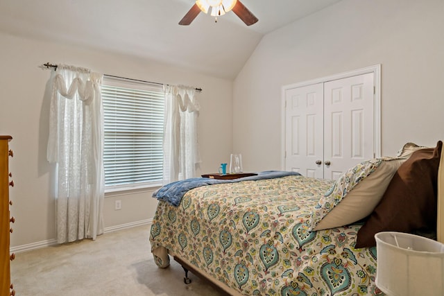 carpeted bedroom with a closet, ceiling fan, and lofted ceiling