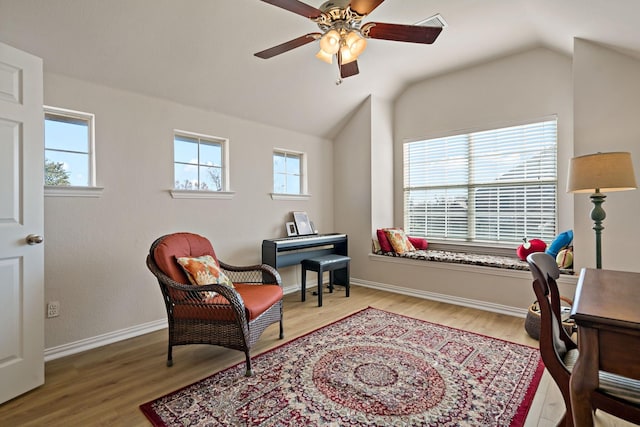 living area featuring hardwood / wood-style flooring, plenty of natural light, and lofted ceiling