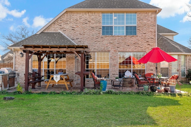 rear view of property with a yard and a patio area