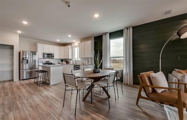 dining area with light hardwood / wood-style floors