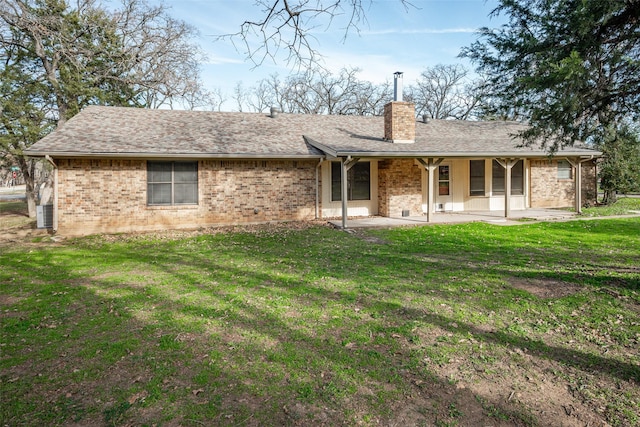 back of house with a lawn and a patio area