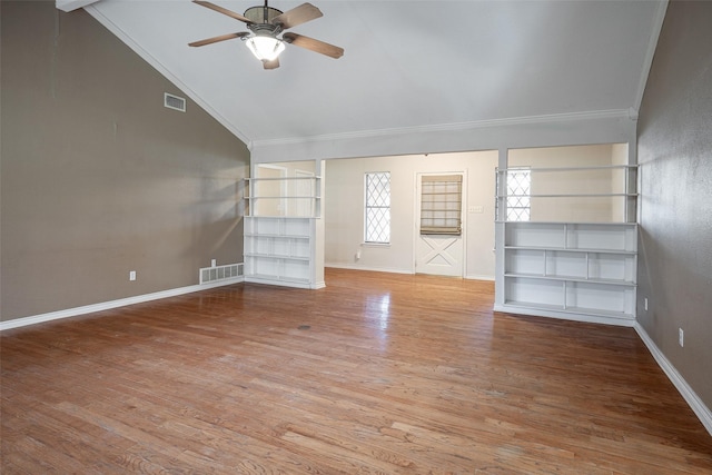 unfurnished living room featuring ceiling fan, wood-type flooring, lofted ceiling, and crown molding