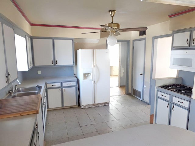 kitchen featuring ceiling fan, white appliances, sink, and white cabinets