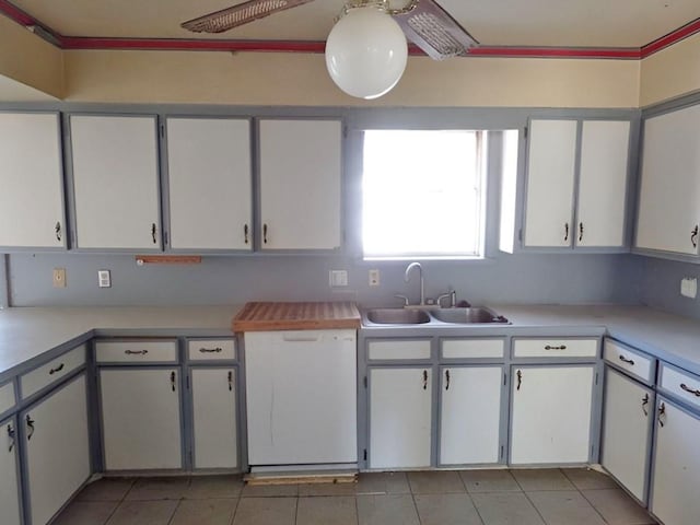 kitchen featuring white cabinetry, sink, and light tile patterned floors