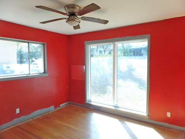 empty room with hardwood / wood-style flooring and ceiling fan