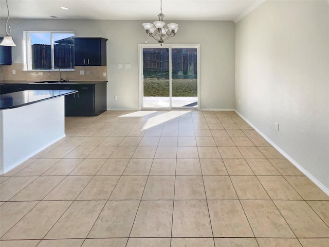 kitchen featuring tasteful backsplash, hanging light fixtures, a notable chandelier, and light tile patterned flooring