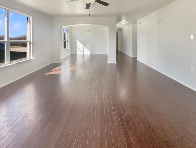 spare room with dark hardwood / wood-style floors and ceiling fan with notable chandelier