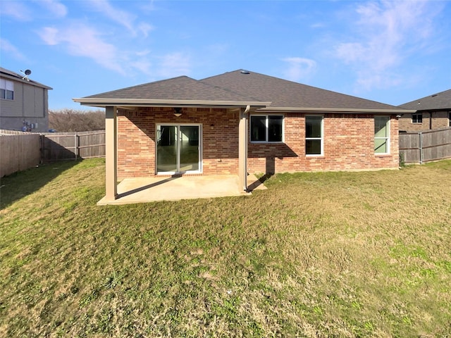 rear view of house with a patio area and a lawn