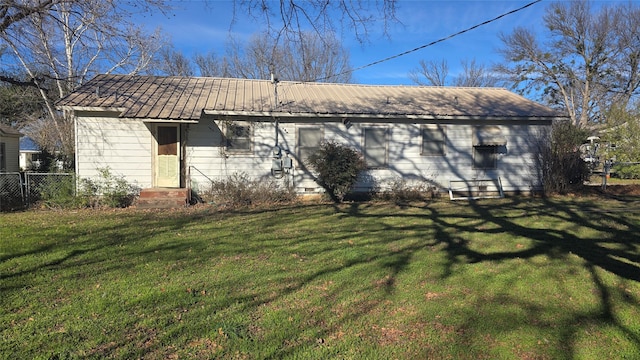 rear view of house with a lawn