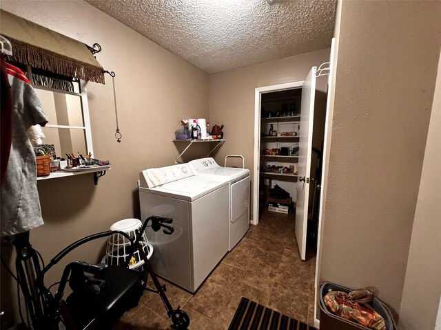1030 Laurel Ln, Paris, TX 75460 - clothes washing area with tile patterned floors, laundry area, a textured ceiling, and washer and clothes dryer