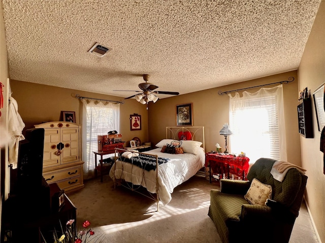 1030 Laurel Ln, Paris, TX 75460 - carpeted bedroom featuring a textured ceiling, a ceiling fan, and visible vents