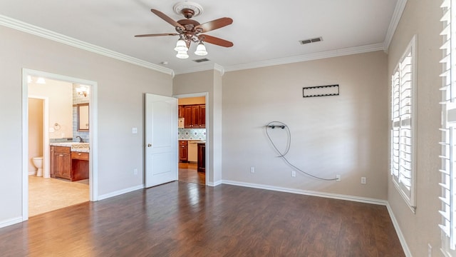 unfurnished bedroom with connected bathroom, ceiling fan, sink, dark wood-type flooring, and ornamental molding