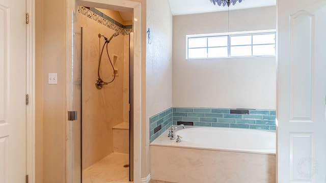 bathroom featuring separate shower and tub