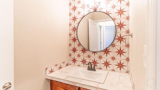 bathroom featuring vanity and tasteful backsplash