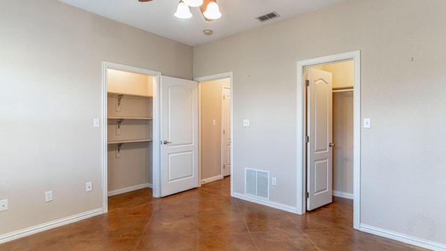 unfurnished bedroom with ceiling fan, a spacious closet, and a closet