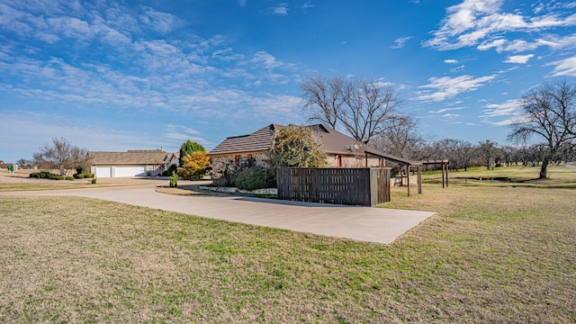 view of property exterior featuring a carport and a yard