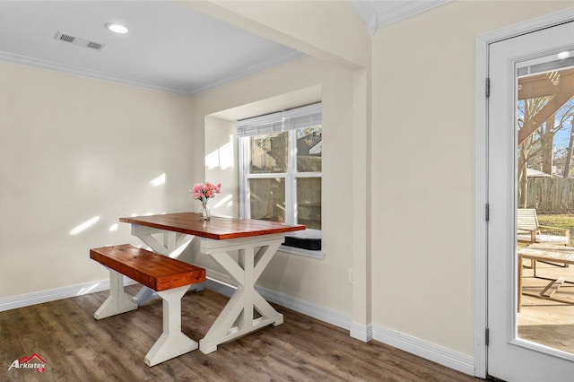 dining room with dark hardwood / wood-style floors and crown molding