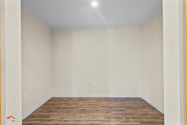 spare room with wood-type flooring and ornamental molding