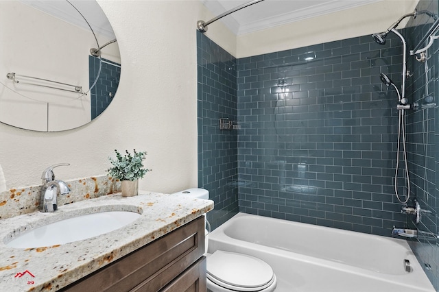 full bathroom featuring toilet, vanity, tiled shower / bath combo, and ornamental molding