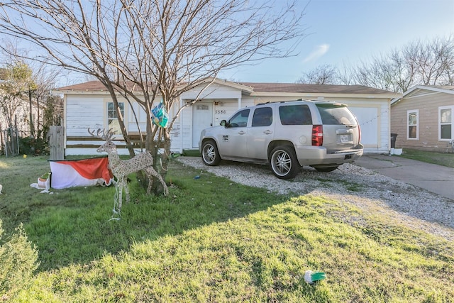 exterior space featuring a garage and a lawn