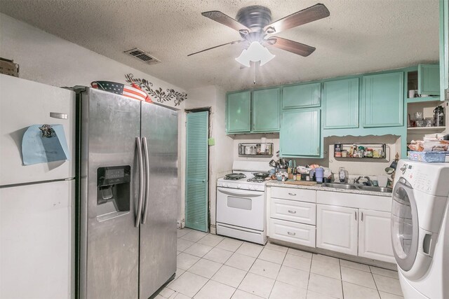 kitchen featuring light stone countertops, appliances with stainless steel finishes, white cabinets, and sink