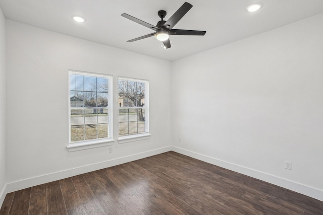 empty room featuring ceiling fan and dark hardwood / wood-style flooring