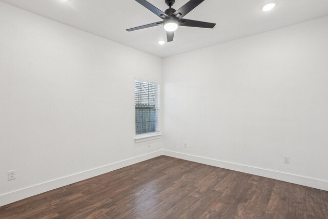 empty room with dark hardwood / wood-style flooring and ceiling fan