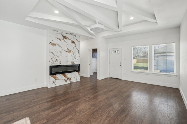 unfurnished living room with beam ceiling, coffered ceiling, dark hardwood / wood-style floors, and a high end fireplace