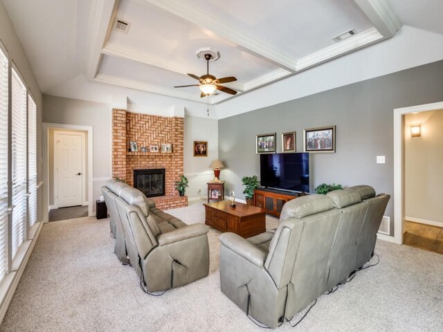 living room featuring a wealth of natural light, light carpet, ceiling fan, and a brick fireplace