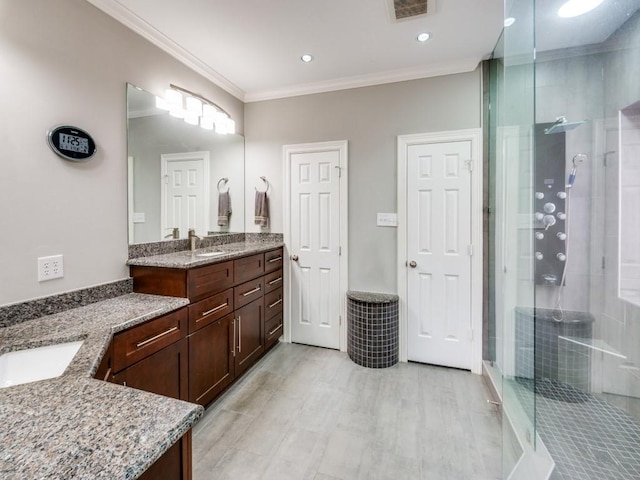 bathroom featuring vanity, an enclosed shower, and ornamental molding