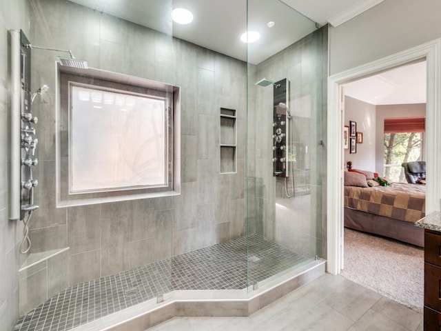 bathroom with tiled shower and tile patterned floors