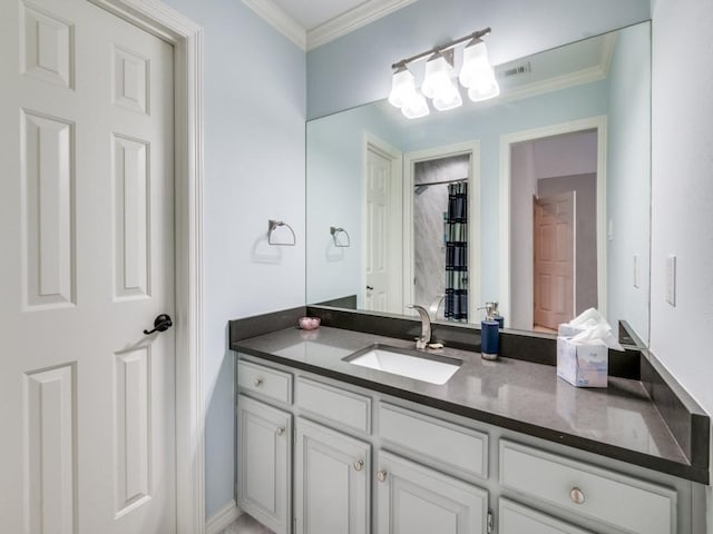 bathroom featuring crown molding and vanity