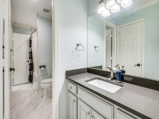 bathroom featuring vanity, ornamental molding, and toilet