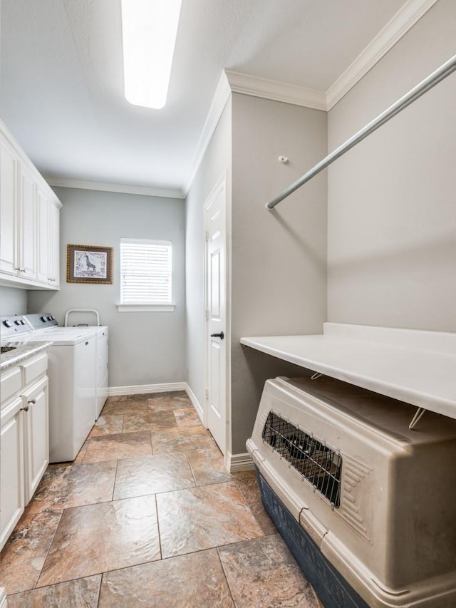 laundry area featuring washer and dryer, cabinets, and ornamental molding