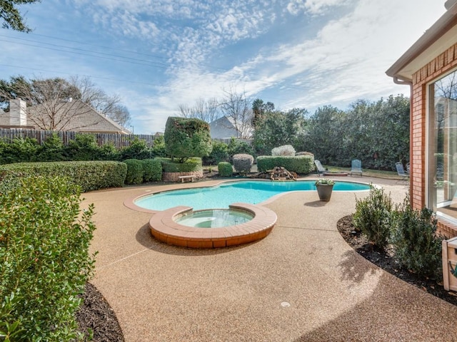 view of pool with an in ground hot tub and a patio