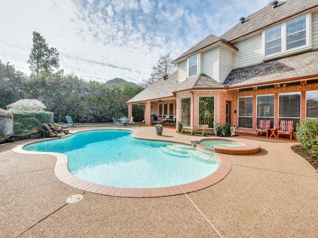 view of pool with an in ground hot tub and a patio